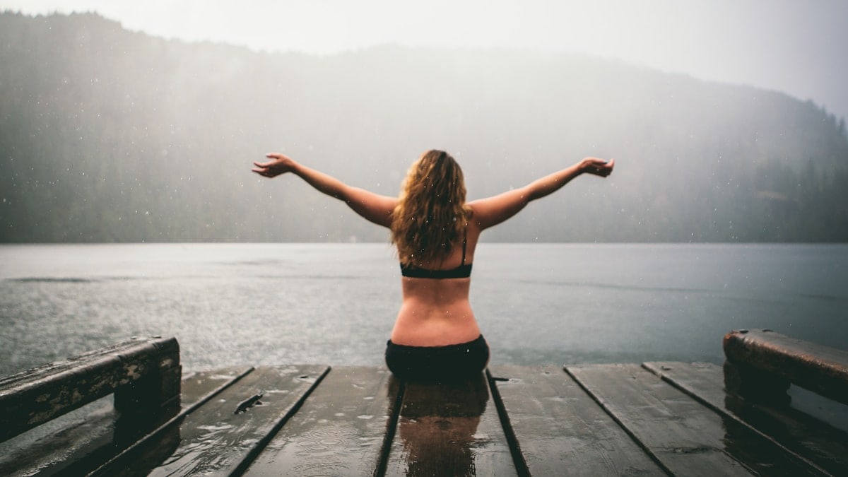 woman sitting on wooden dock